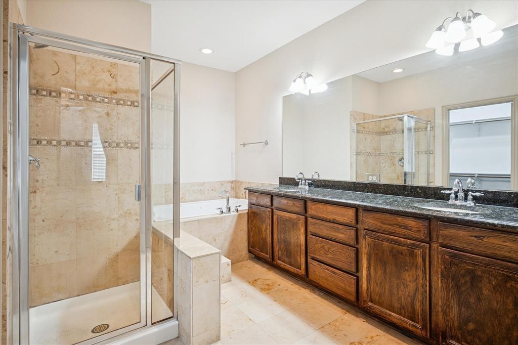 3808 Vienna Street Irving, TX 75038 - Photo 11 of 22 a bathroom with a double vanity sink mirror and shower
