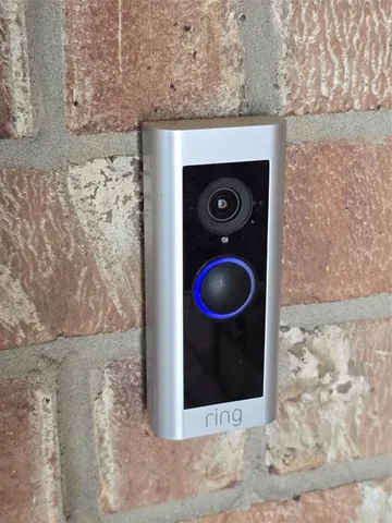 a view of wooden door with red wall clock