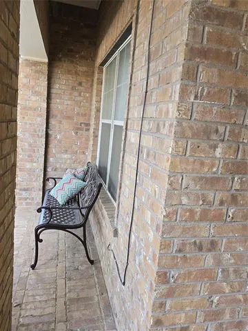 a balcony with a couch and a table
