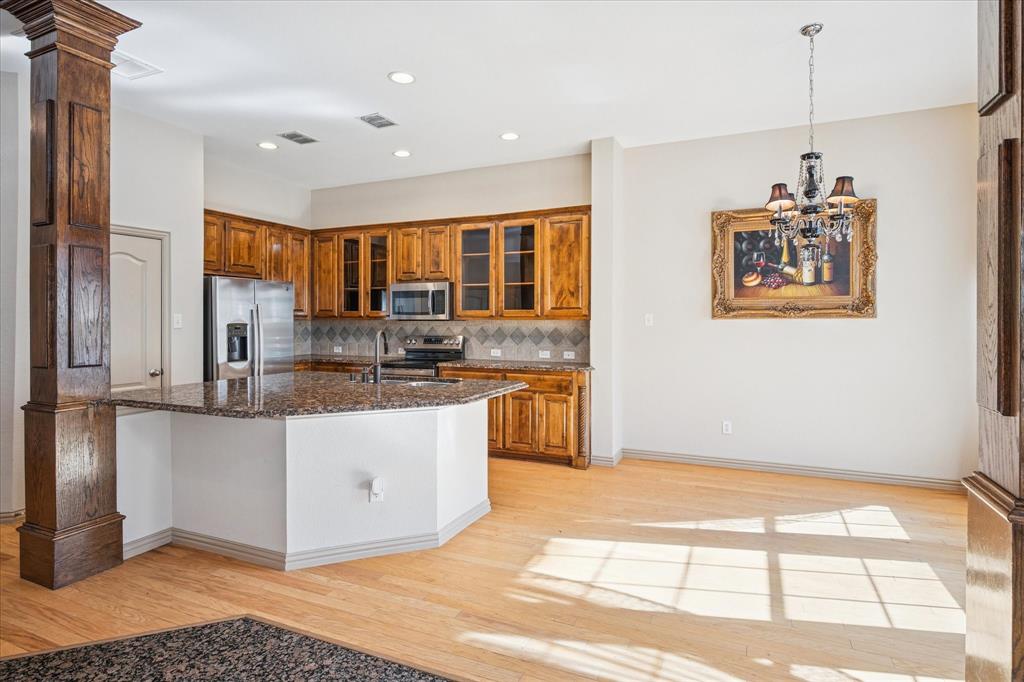 3808 Vienna Street Irving, TX 75038 - Photo 7 of 22 a kitchen with stainless steel appliances granite countertop a stove a sink and a refrigerator