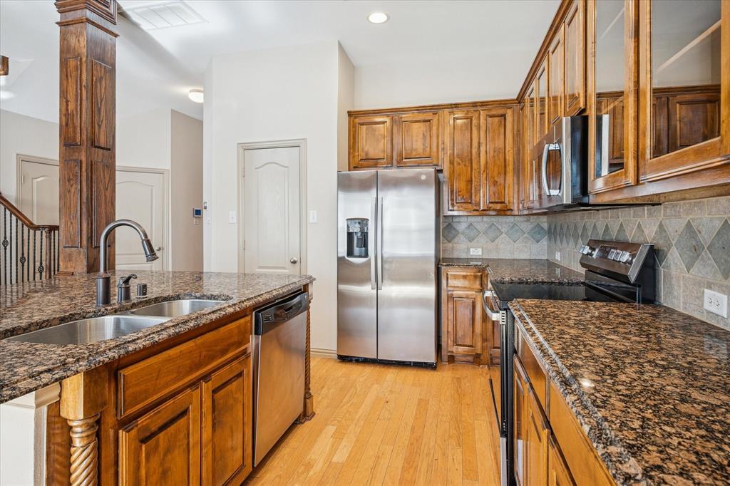 3808 Vienna Street Irving, TX 75038 - Photo 8 of 22 a kitchen with stainless steel appliances granite countertop a sink and a refrigerator