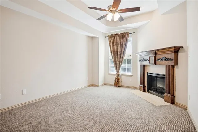 a view of empty room with fireplace and fan