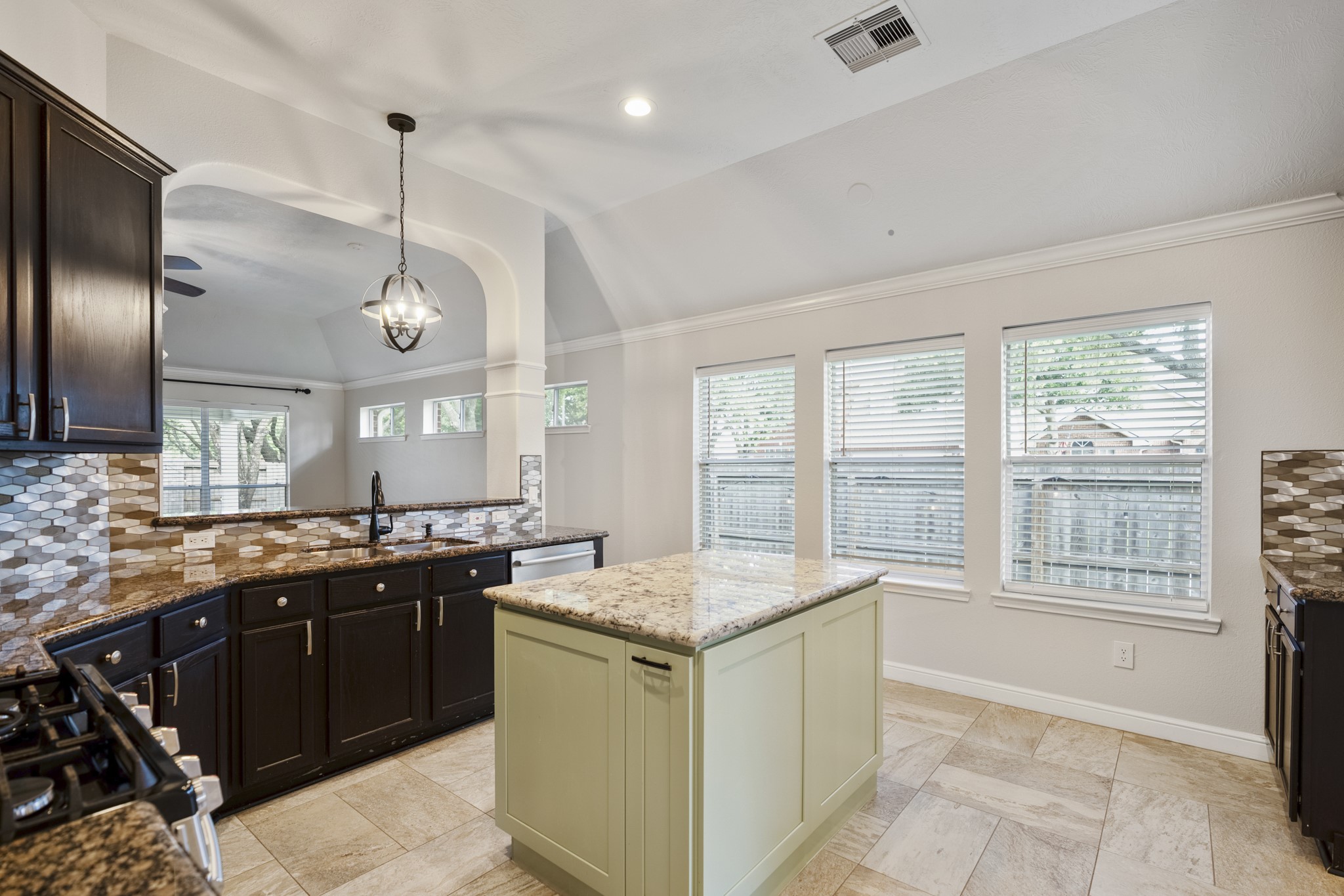 5802 Sawyer Bend Lane Spring, TX 77379 - Photo 8 of 50 a kitchen with granite countertop a sink stove and refrigerator