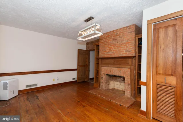 a view of an empty room and fire place