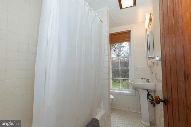 a bathroom with a sink toilet