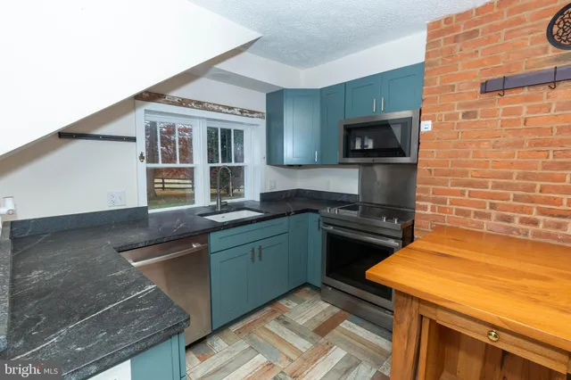 a kitchen with a sink and a stove top oven