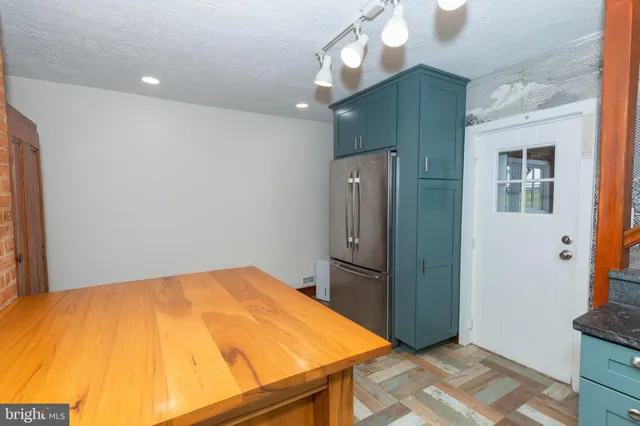 a room with a bed and chandelier