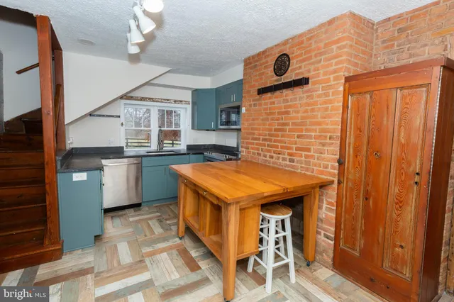 a kitchen with a stove a refrigerator and cabinets
