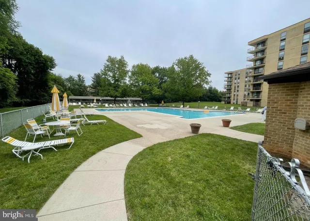 a view of a swimming pool and lounge chairs