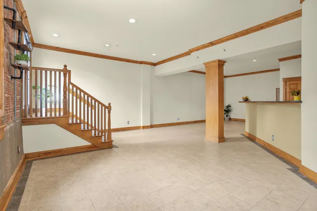 a view of a kitchen with furniture and an empty room