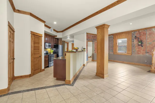 a kitchen with stainless steel appliances granite countertop sink stove refrigerator and cabinets