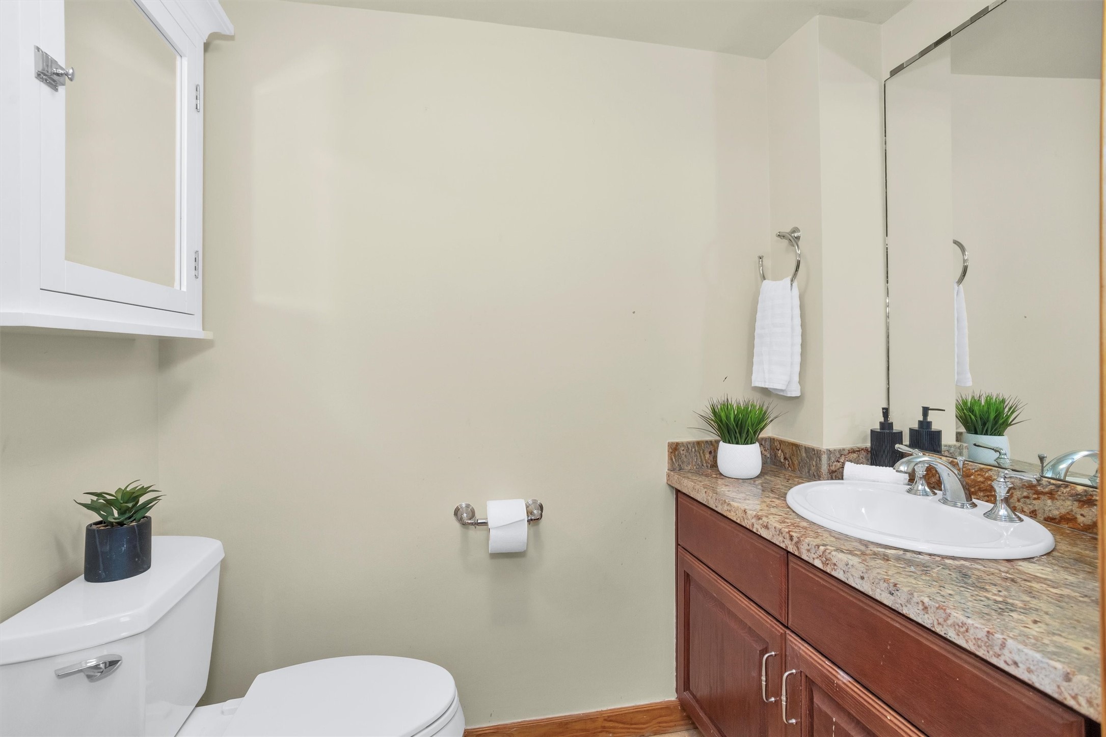 215 West Norma Street, Unit 104 Houston, TX 77009 - Photo 22 of 37 a bathroom with a granite countertop toilet sink and mirror