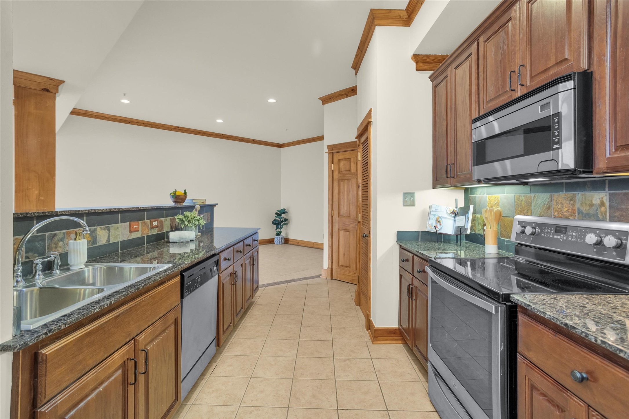 215 West Norma Street, Unit 104 Houston, TX 77009 - Photo 3 of 37 a kitchen with stainless steel appliances granite countertop a sink and stove