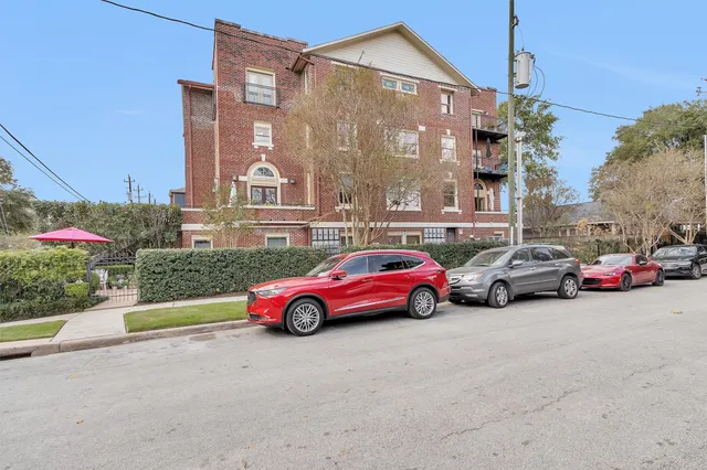 a view of a brick building next to a yard