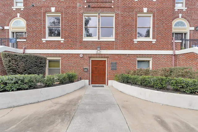 a hallway with windows and chandelier