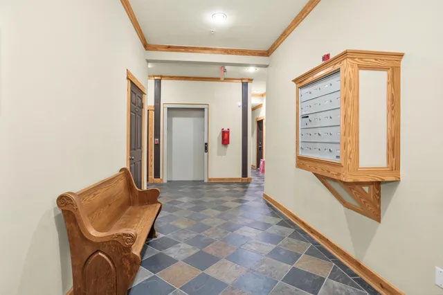 a view of a hallway with wooden shelves