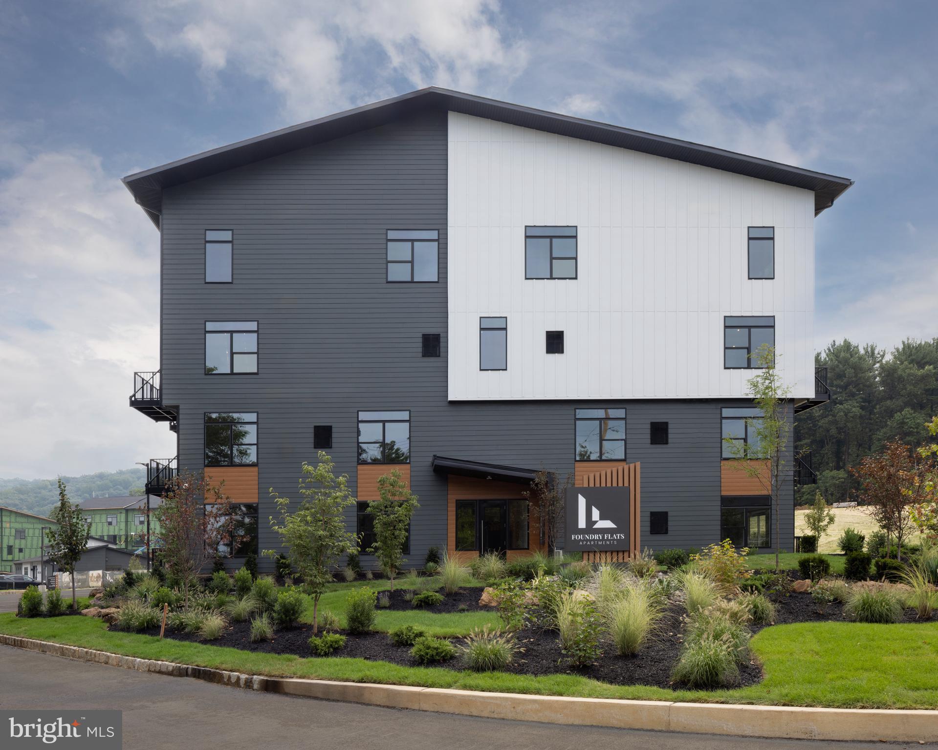 300 Furnace Street, Unit 107 Emmaus, PA 18049 - Photo 2 of 7 a front view of a house with a yard