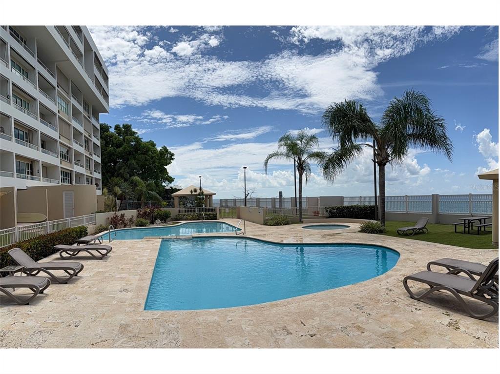 Condo Pelican Reef Condo Pelican Reef, Unit 302 Rincon, PR 00677 - Photo 12 of 16 a view of a swimming pool with a lounge chair