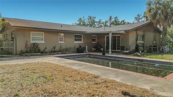 a front view of a house with a yard outdoor seating and barbeque oven