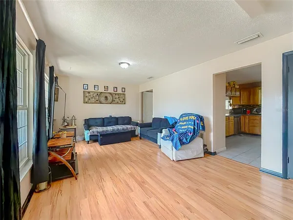 a bedroom with furniture and a wooden floor