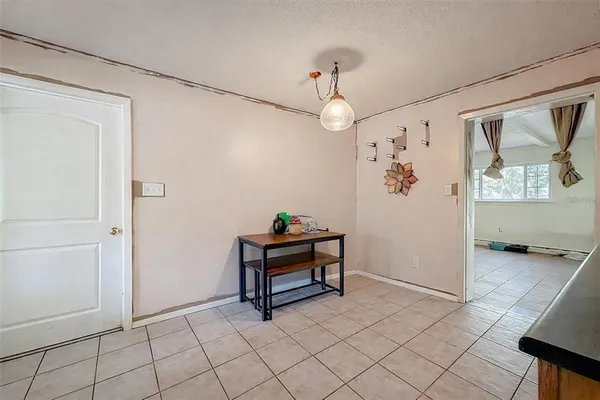 a room with chandelier fan and windows