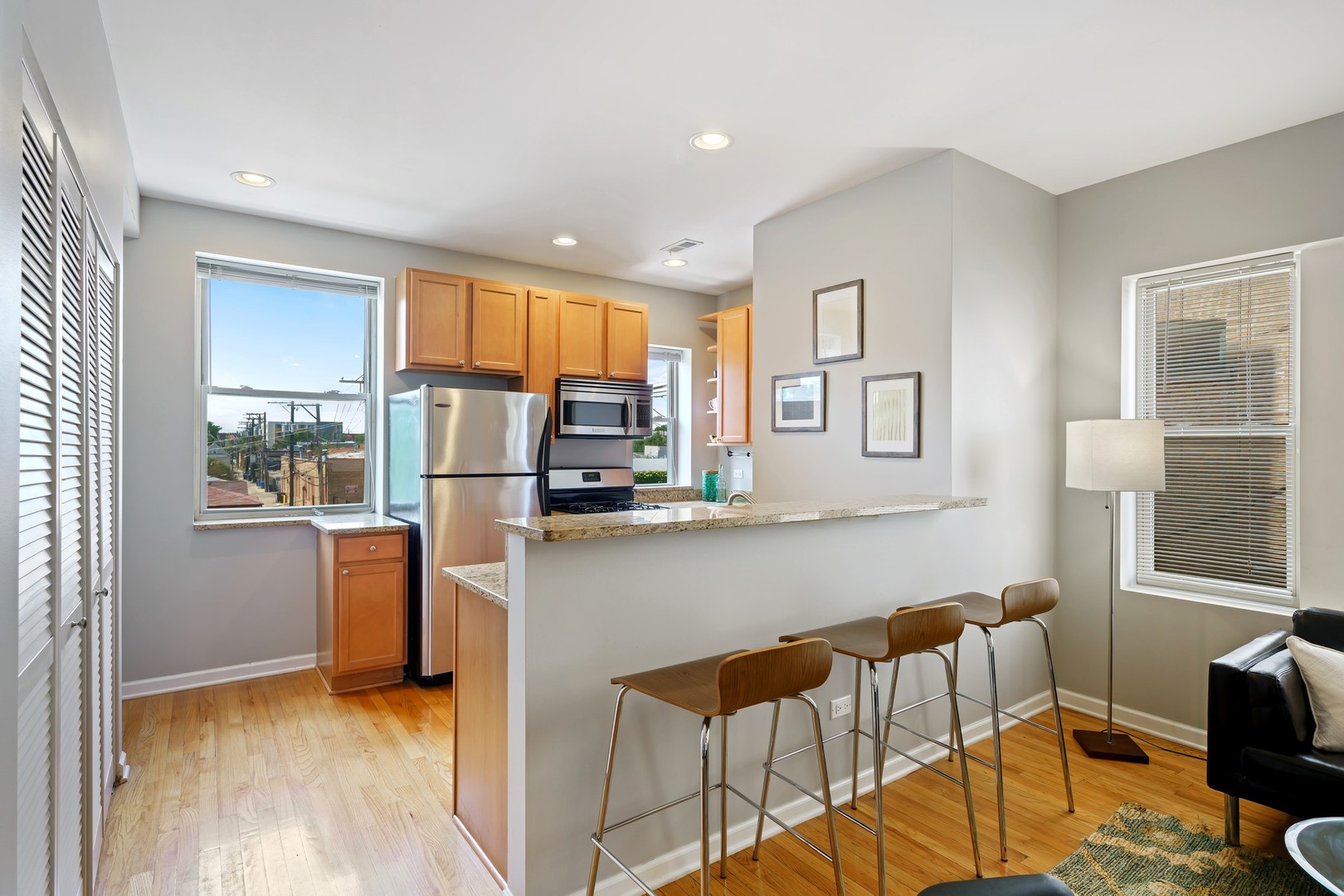 4344 North Spaulding Avenue, Unit 2 Chicago, IL 60618 - Photo 5 of 15 a kitchen with stainless steel appliances granite countertop a refrigerator and a stove top oven
