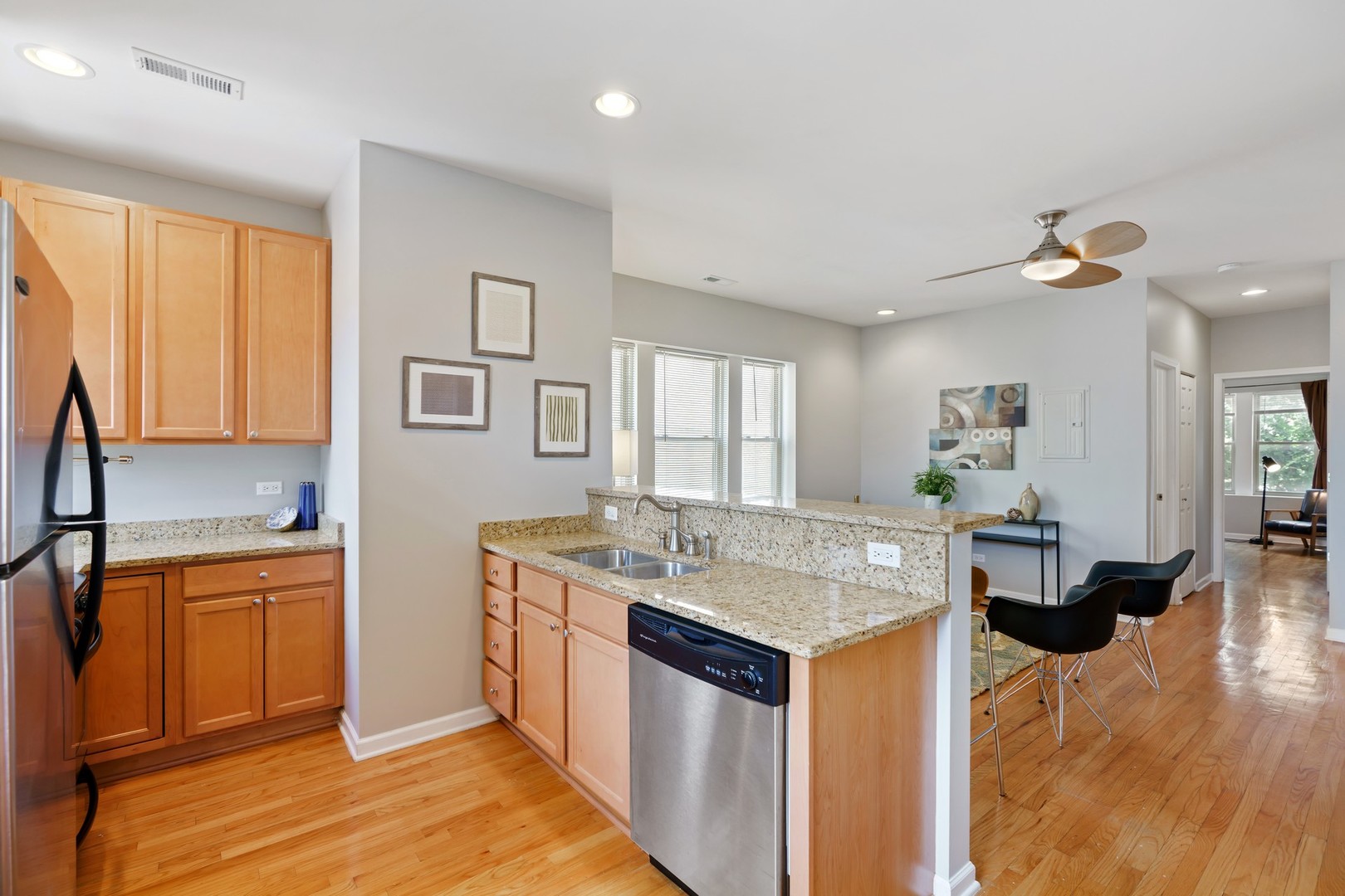 4344 North Spaulding Avenue, Unit 2 Chicago, IL 60618 - Photo 6 of 15 a open kitchen with stainless steel appliances granite countertop a sink and dishwasher with wooden floor