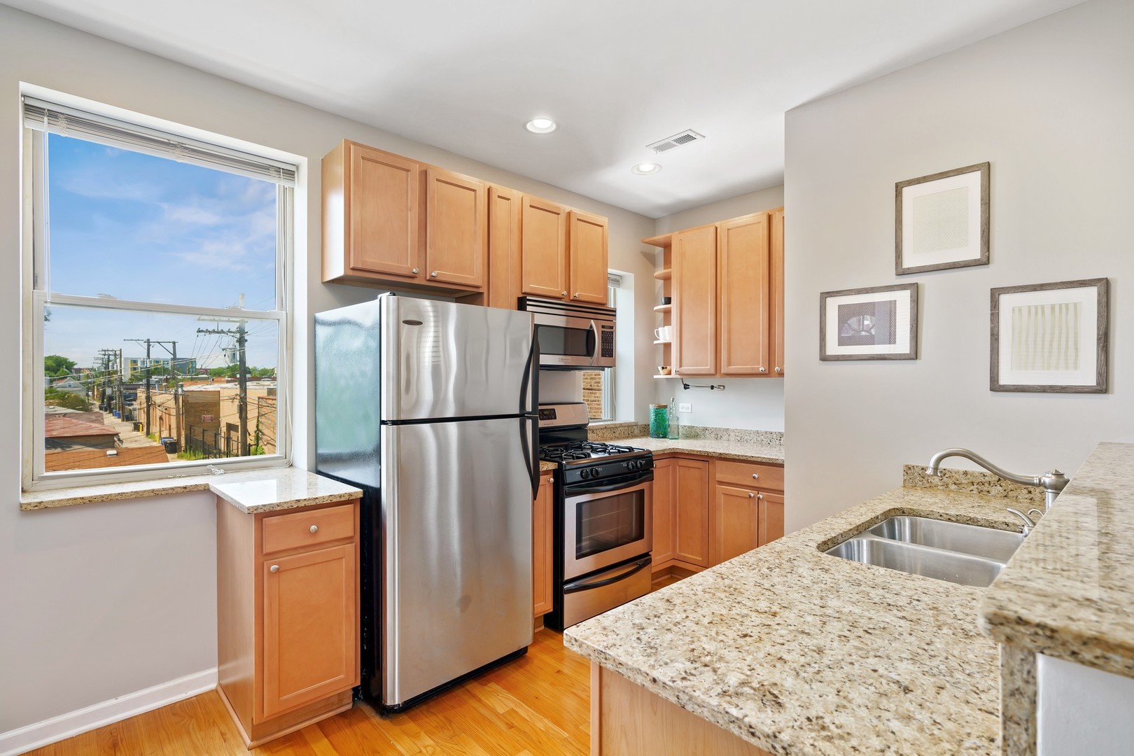 4344 North Spaulding Avenue, Unit 2 Chicago, IL 60618 - Photo 7 of 15 a kitchen with granite countertop a refrigerator stove top oven and sink
