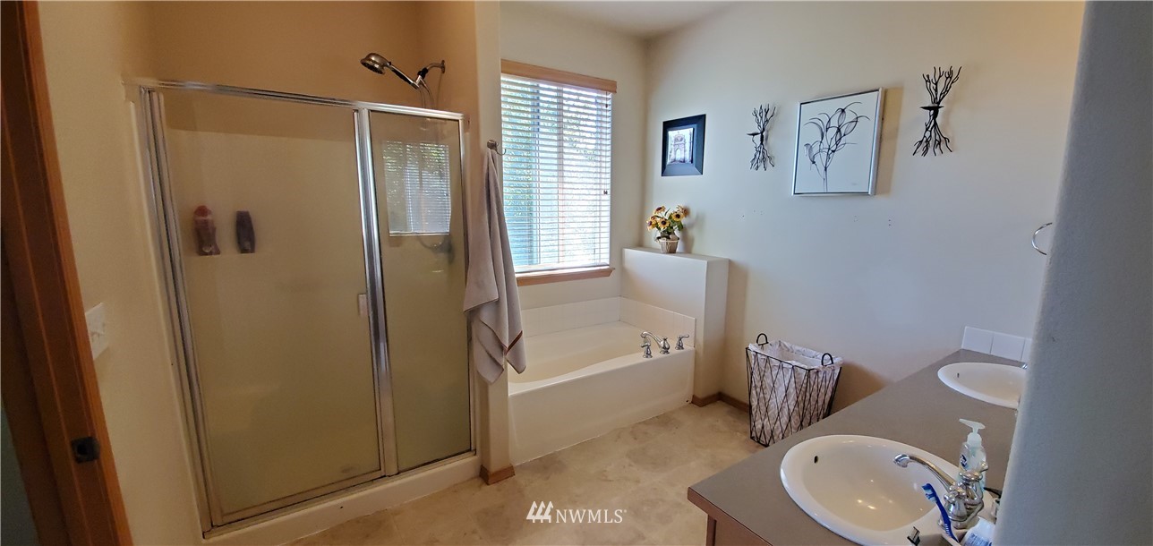 7365 Radius Loop Southeast Lacey, WA 98513 - Photo 17 of 28 a bathroom with a sink toilet and shower