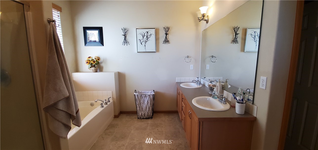 7365 Radius Loop Southeast Lacey, WA 98513 - Photo 18 of 28 a bathroom with a sink toilet and shower