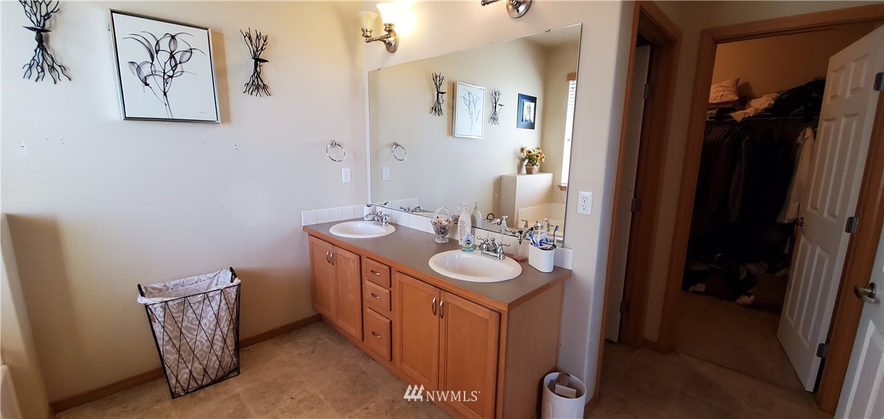 7365 Radius Loop Southeast Lacey, WA 98513 - Photo 19 of 28 a bathroom with a sink and a mirror