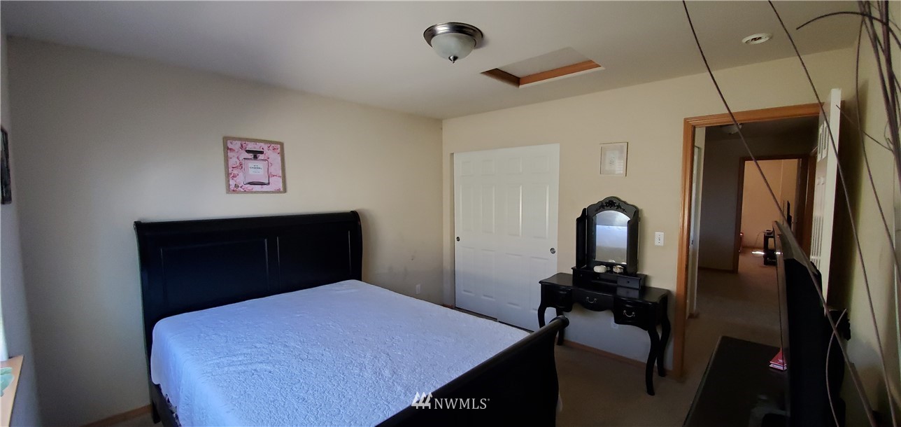7365 Radius Loop Southeast Lacey, WA 98513 - Photo 20 of 28 a bedroom with a bed and a dresser