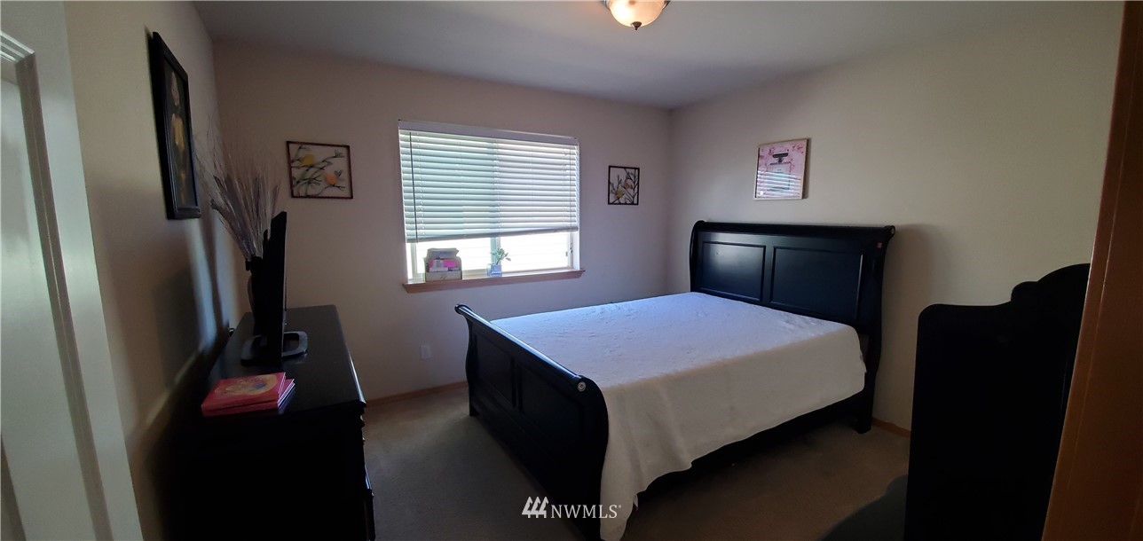 7365 Radius Loop Southeast Lacey, WA 98513 - Photo 21 of 28 a bedroom with a bed and a window