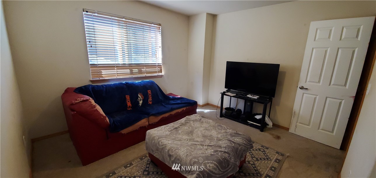 7365 Radius Loop Southeast Lacey, WA 98513 - Photo 24 of 28 a living room with furniture and a flat screen tv