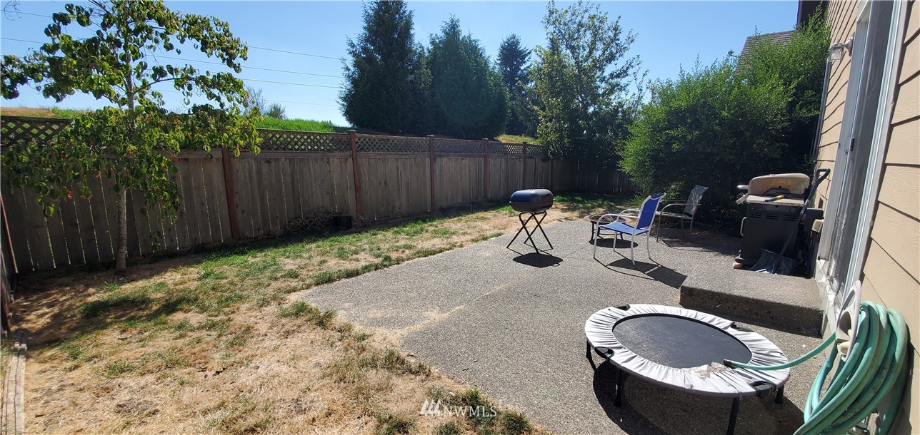 7365 Radius Loop Southeast Lacey, WA 98513 - Photo 27 of 28 a backyard of a house with yard and trampoline