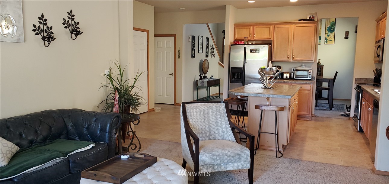 7365 Radius Loop Southeast Lacey, WA 98513 - Photo 9 of 28 a living room with furniture a large window and a dining table