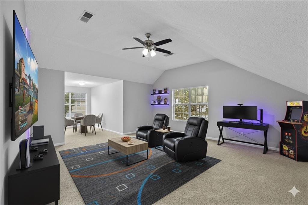 498 Pecan Wood Circle Fairburn, GA 30213 - Photo 12 of 27 a living room with furniture and a flat screen tv