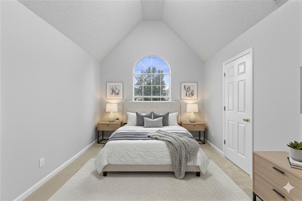 498 Pecan Wood Circle Fairburn, GA 30213 - Photo 13 of 27 a bedroom with a bed and a painting on the wall