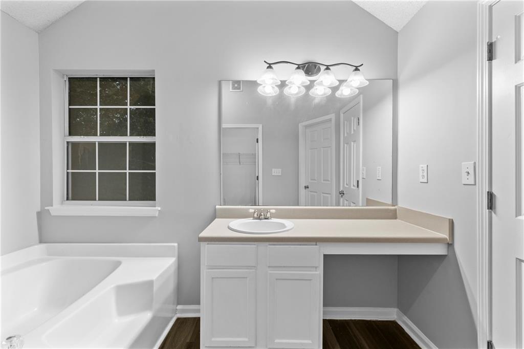 498 Pecan Wood Circle Fairburn, GA 30213 - Photo 16 of 27 a bathroom with a sink and a bathtub