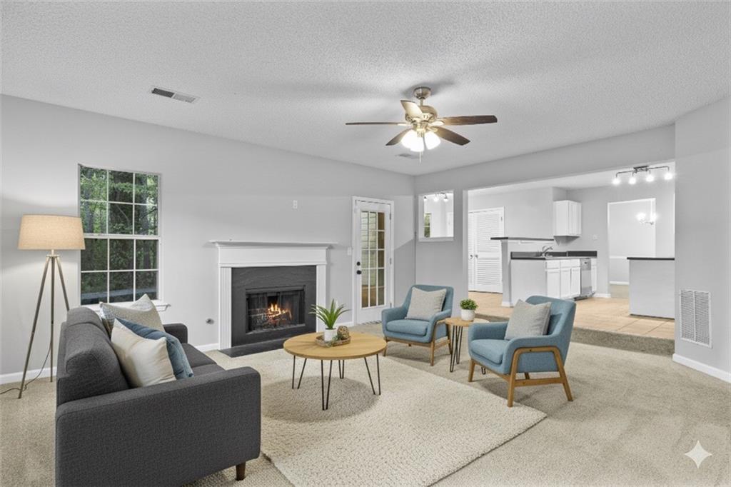 498 Pecan Wood Circle Fairburn, GA 30213 - Photo 2 of 27 a living room with furniture and a fireplace