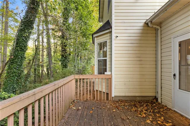 a balcony with wooden floor and fence
