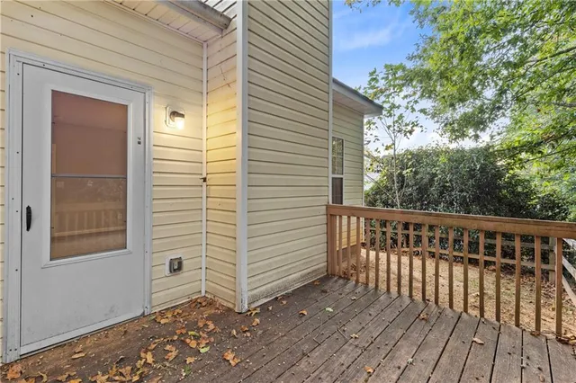 a backyard of a house with barbeque oven and potted plants