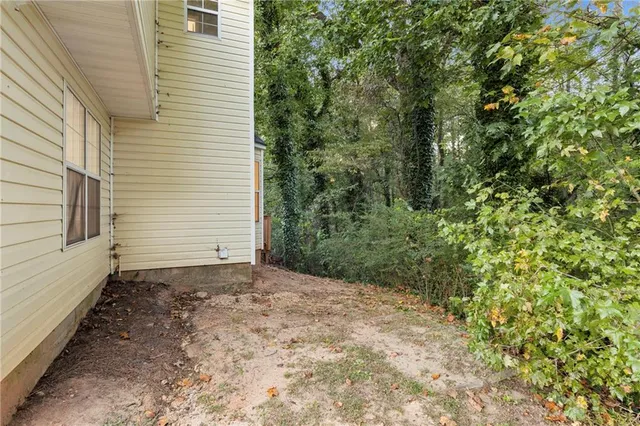 a balcony with wooden floor and outdoor seating