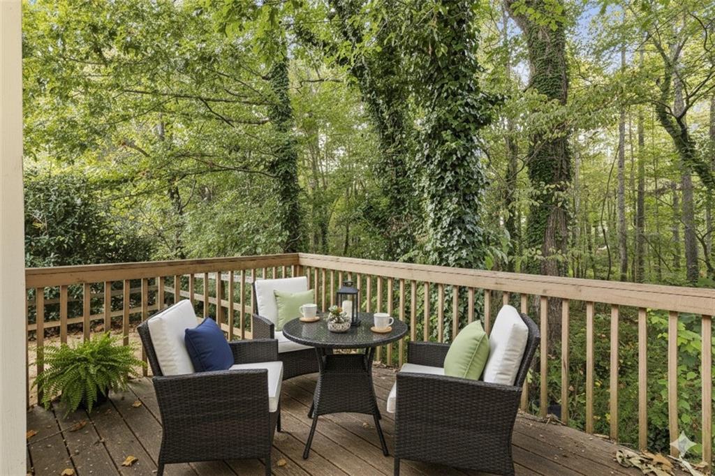 498 Pecan Wood Circle Fairburn, GA 30213 - Photo 27 of 27 a balcony with wooden floor and outdoor seating