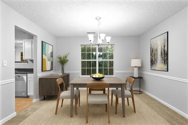 a view of a dining room with furniture and window