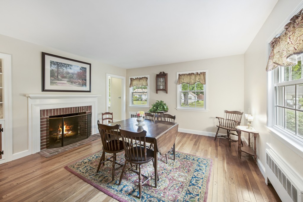 11 Forrest Road Topsfield, MA 01983 - Photo 16 of 30 a dining room with furniture a fireplace and wooden floor