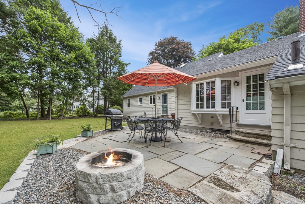 11 Forrest Road Topsfield, MA 01983 - Photo 5 of 30 a patio with a table and chairs and potted plants