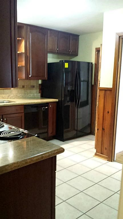 19 Lyncrest Drive Galveston, TX 77550 - Photo 5 of 15 a kitchen with a sink appliances and cabinets