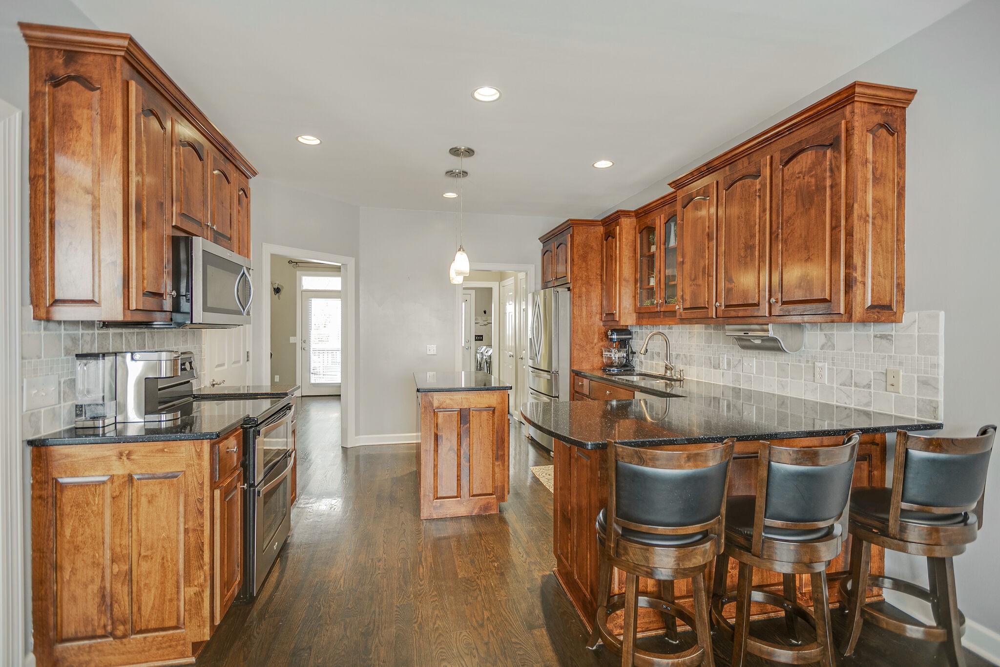 3029 Viewpointe Way Columbia, TN 38401 - Photo 14 of 40 a kitchen with granite countertop wooden cabinets and stainless steel appliances