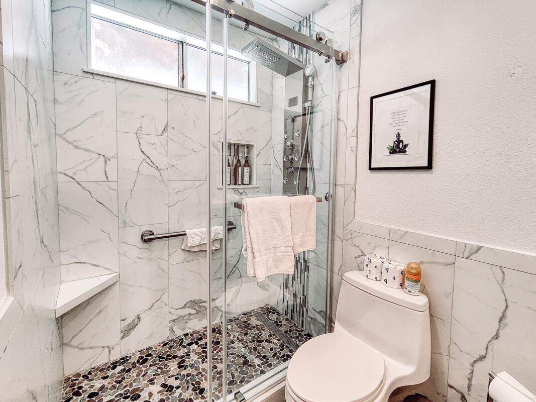 2450 Tamarisk Road Palm Springs, CA 92262 - Photo 19 of 41 a white toilet sitting next to a bathroom sink